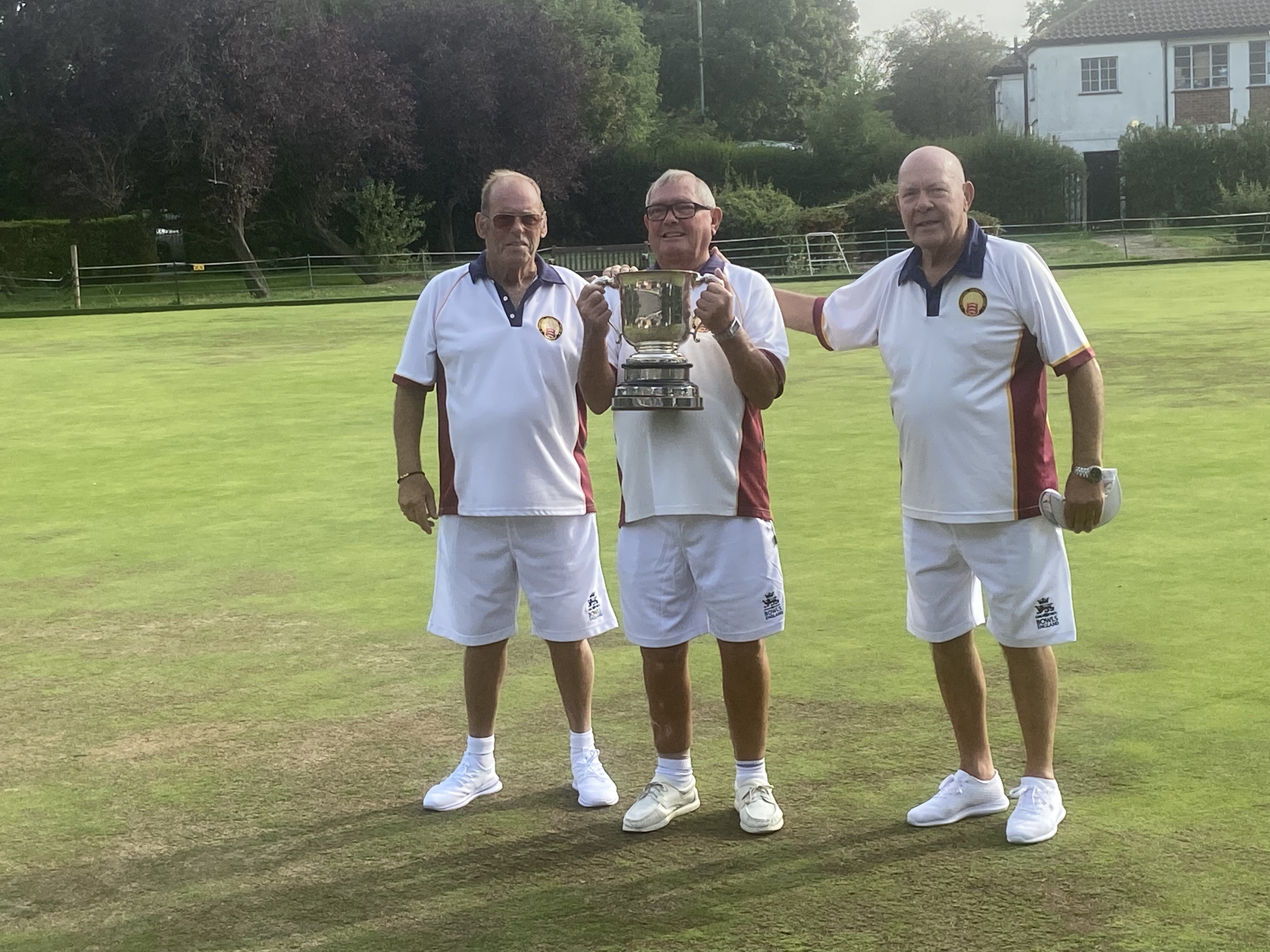 photo showing the romford trio with the trophy.